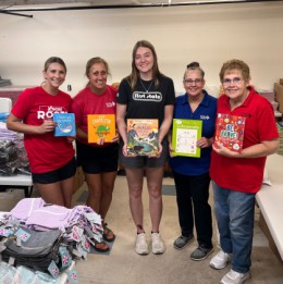 a group of volunteers holding books