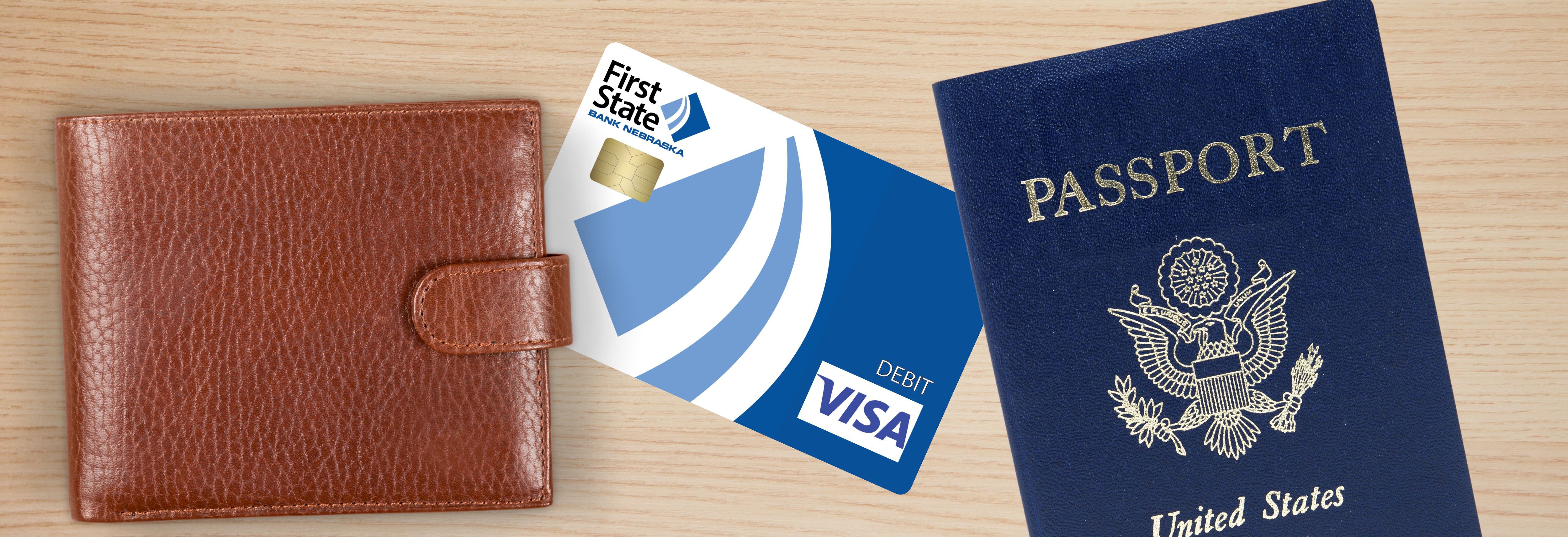 a wallet, debit card and passport on a table