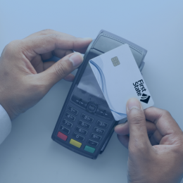hand using a contactless credit card at a payment terminal