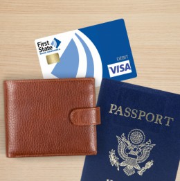 a wallet, debit card and passport on a table