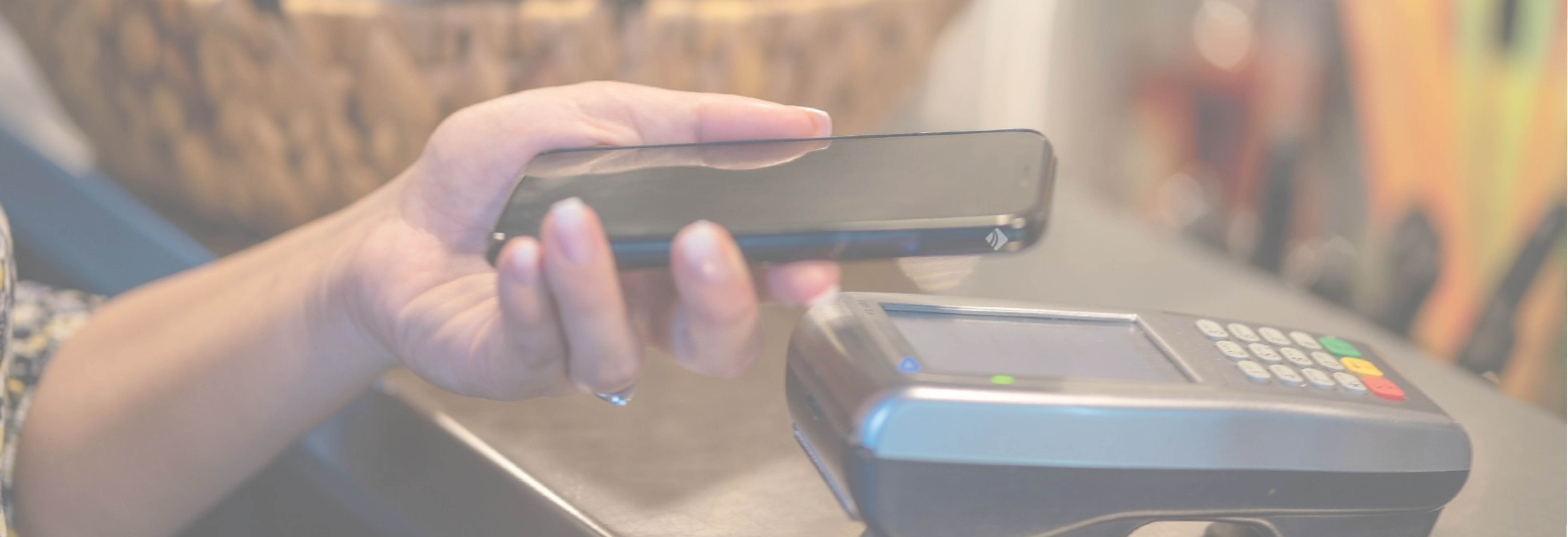 Person paying at register with mobile phone