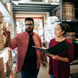 two people standing looking at boxes