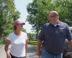 a man and a woman walking outside talking