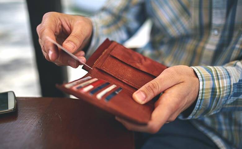 man with a credit card from wallet